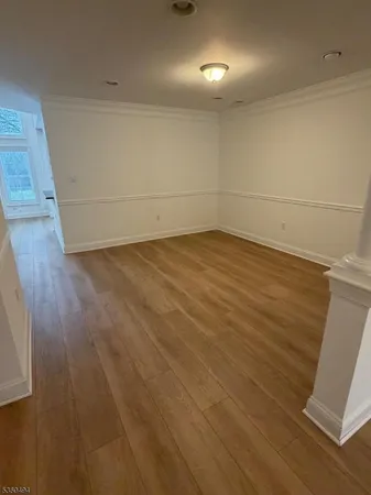an empty room with a ceiling fan and window