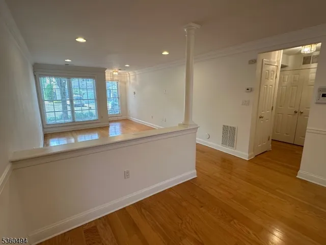 a room with wooden floor and window