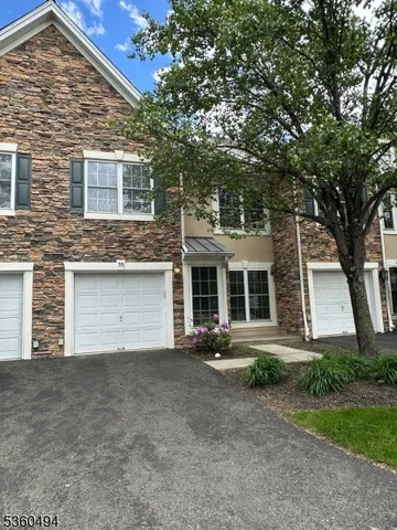 front view of a house with a tree