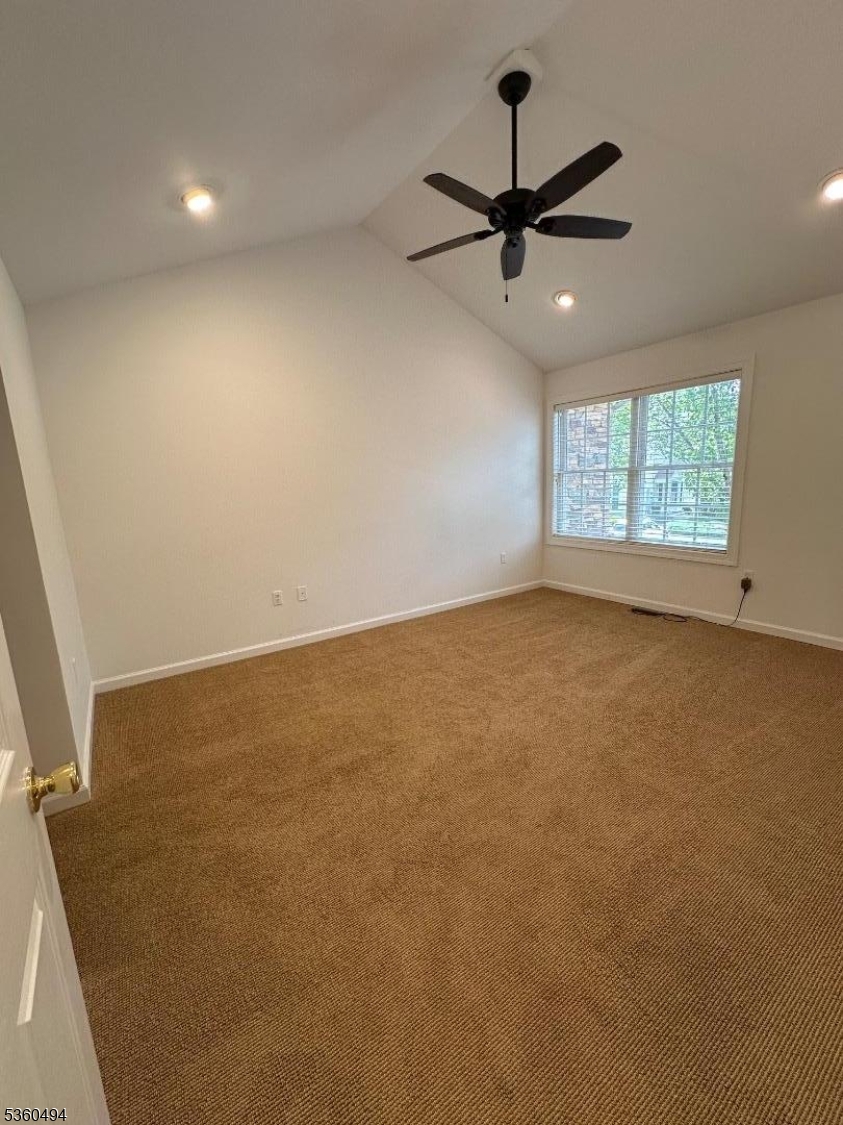 35 Magnolia Way, Unit 35 North Haledon, NJ 07508 - Photo 24 of 34 an empty room with a ceiling fan and window