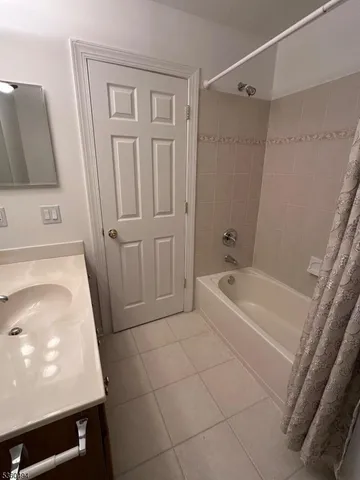 a bathroom with a tub a sink and a shower