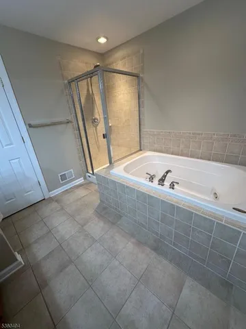 a bathroom with a tub a sink and a shower