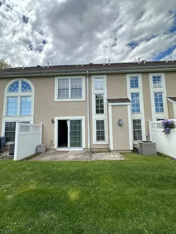 a front view of a house with a garden and yard