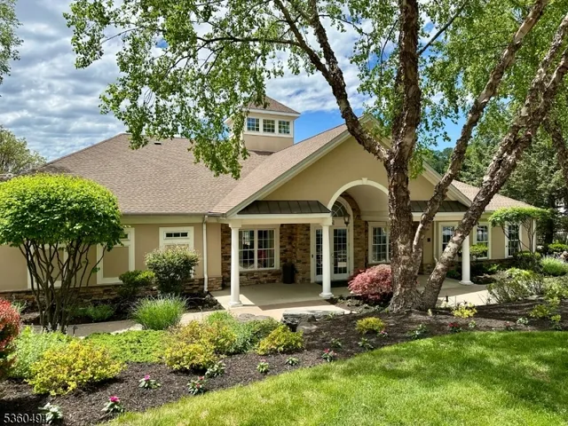 a view of a house with backyard and a tree