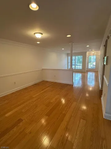 a view of a room with wooden floor