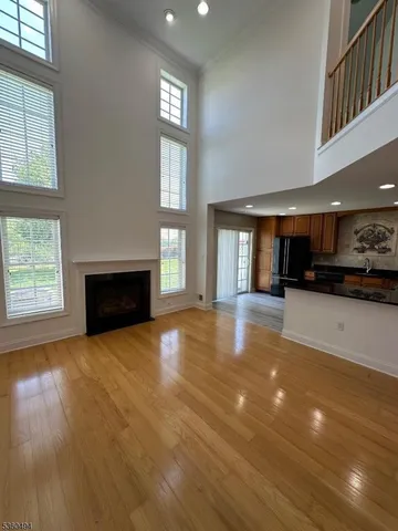 a view of an empty room with window and fire place