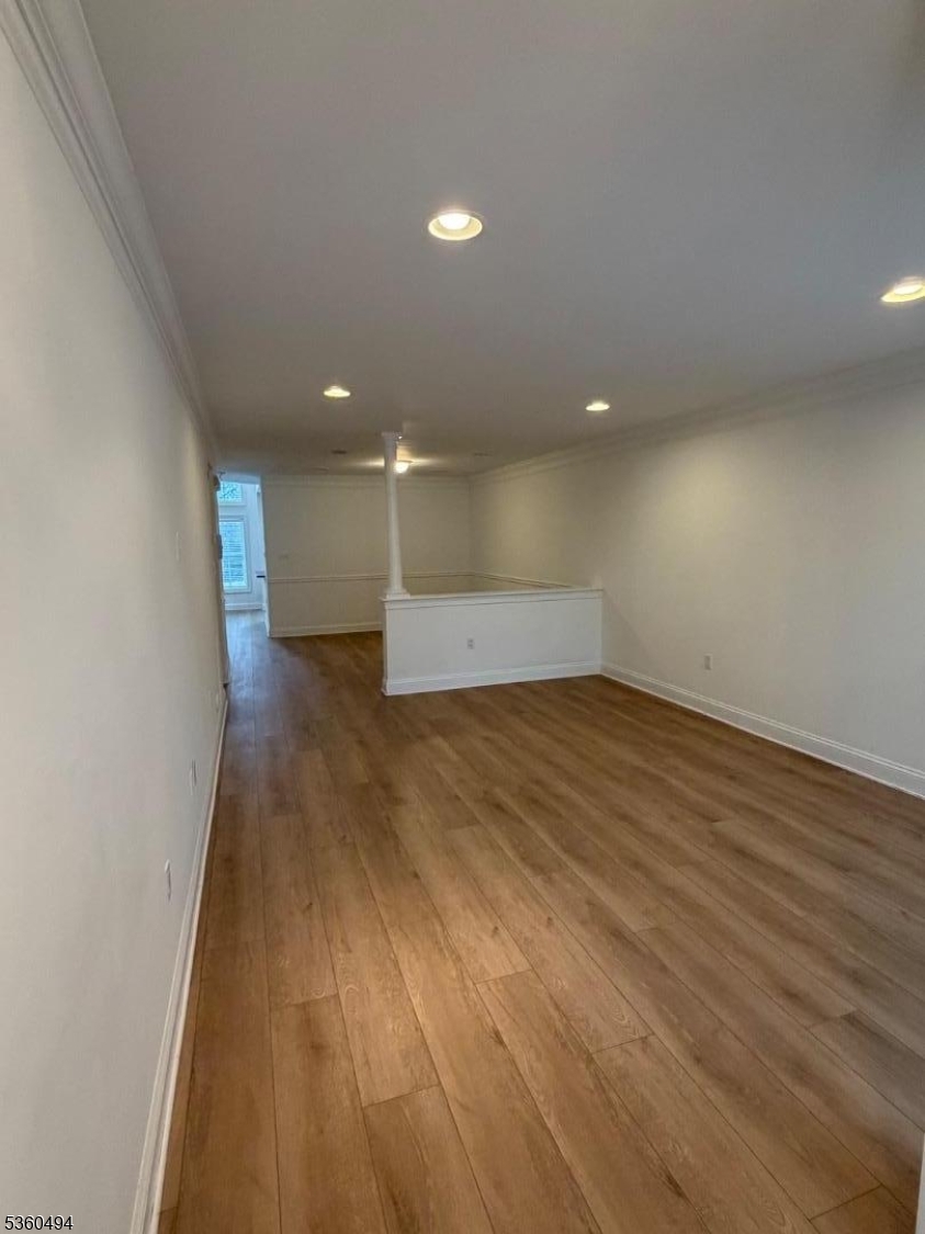 35 Magnolia Way, Unit 35 North Haledon, NJ 07508 - Photo 10 of 34 an empty room with wooden floor and windows