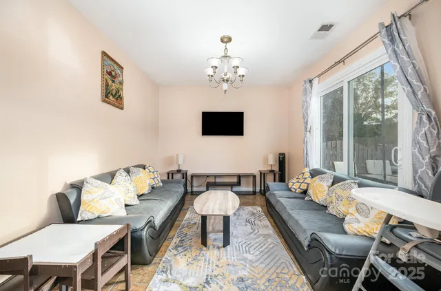 a living room with furniture and a flat screen tv