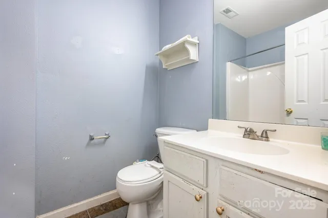 a bathroom with a sink mirror vanity and toilet