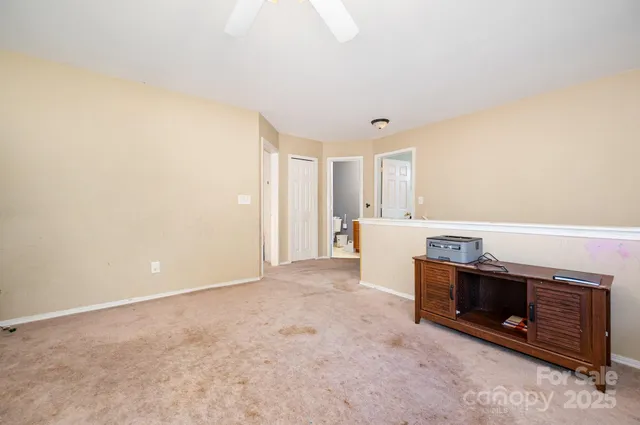 a view of an empty room with a fireplace