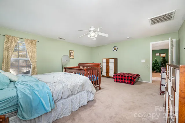 a bedroom with a bed and window