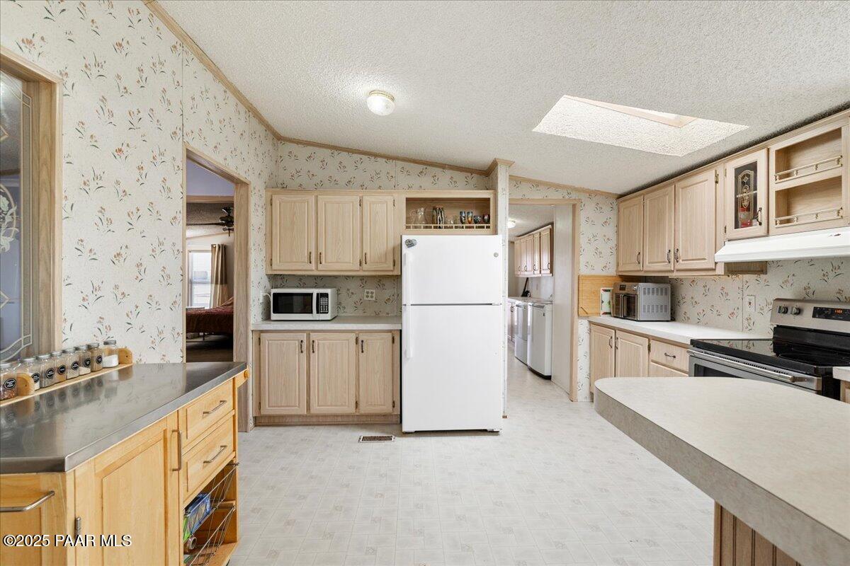 24725 North Patricia Road Paulden, AZ 86334 - Photo 13 of 36 a kitchen with cabinets stainless steel appliances and a counter space