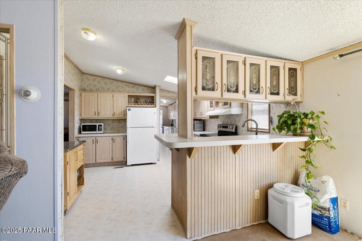 24725 North Patricia Road Paulden, AZ 86334 - Photo 14 of 36 a kitchen with white cabinets and refrigerator