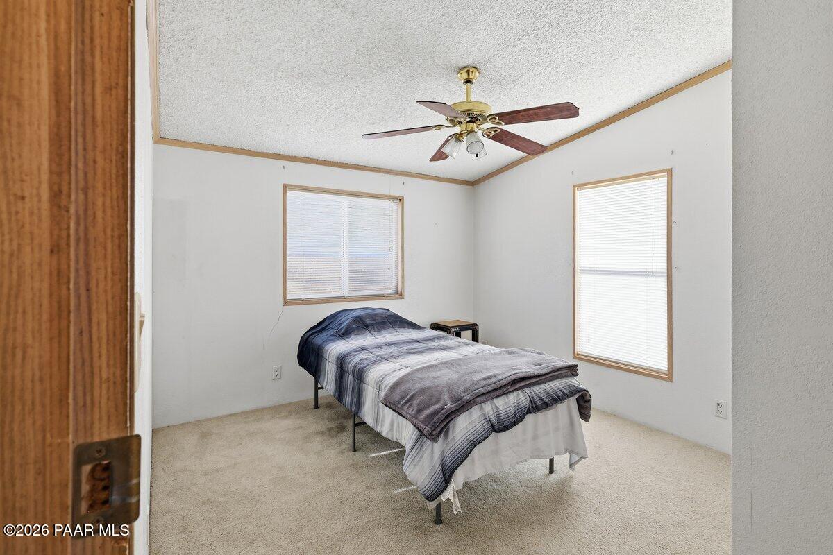 24725 North Patricia Road Paulden, AZ 86334 - Photo 15 of 30 a bedroom with a bed and a window