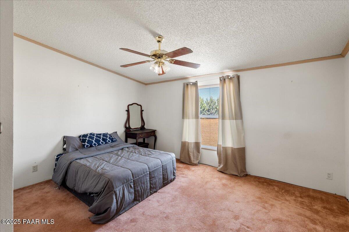 24725 North Patricia Road Paulden, AZ 86334 - Photo 16 of 36 a bedroom with a bed next to a window