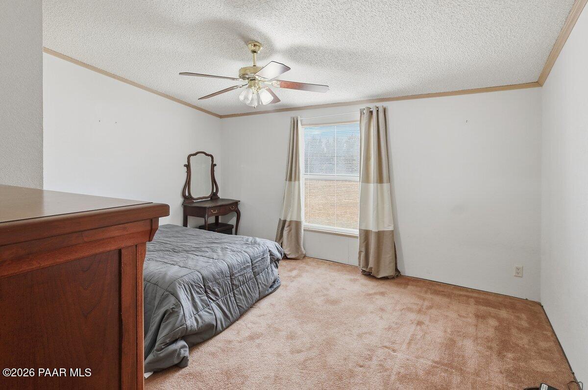 24725 North Patricia Road Paulden, AZ 86334 - Photo 16 of 30 a bedroom with a bed and a chandelier