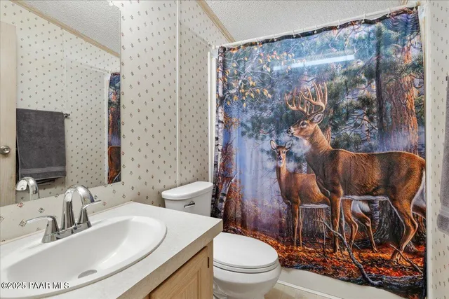 a spacious bedroom with a bed and a ceiling fan