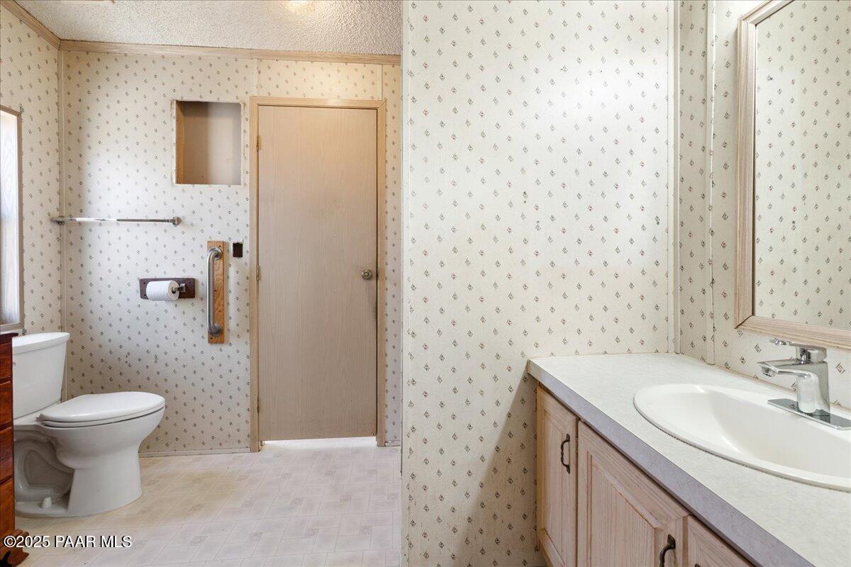24725 North Patricia Road Paulden, AZ 86334 - Photo 19 of 36 a bathroom with a sink toilet and a mirror