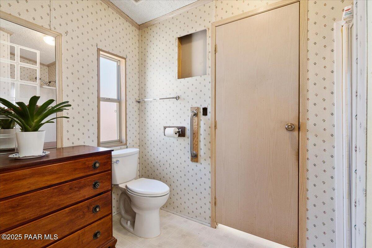 24725 North Patricia Road Paulden, AZ 86334 - Photo 21 of 36 a bathroom with a toilet a sink and a window