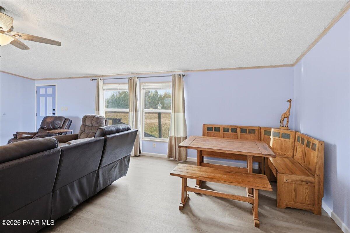 24725 North Patricia Road Paulden, AZ 86334 - Photo 6 of 30 a living room with furniture a rug potted plant and a window