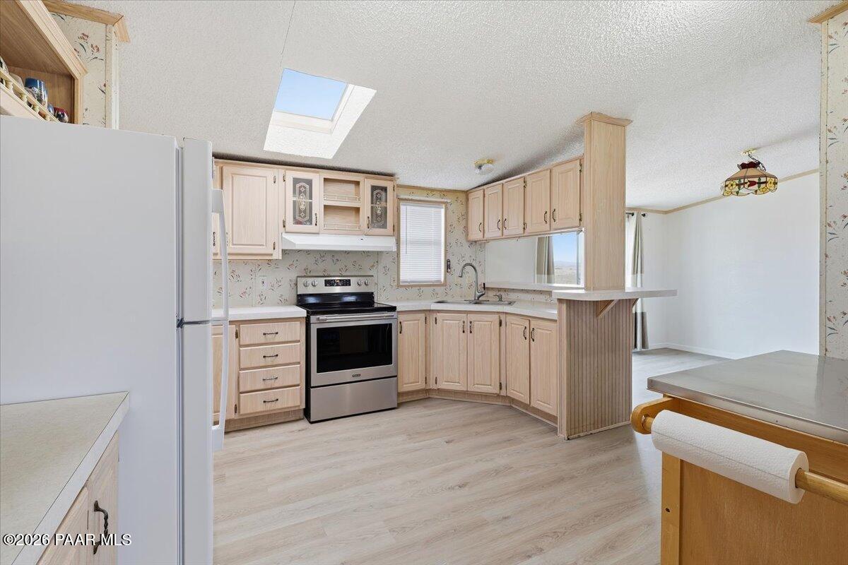 24725 North Patricia Road Paulden, AZ 86334 - Photo 7 of 30 a kitchen with a white cabinets and white appliances