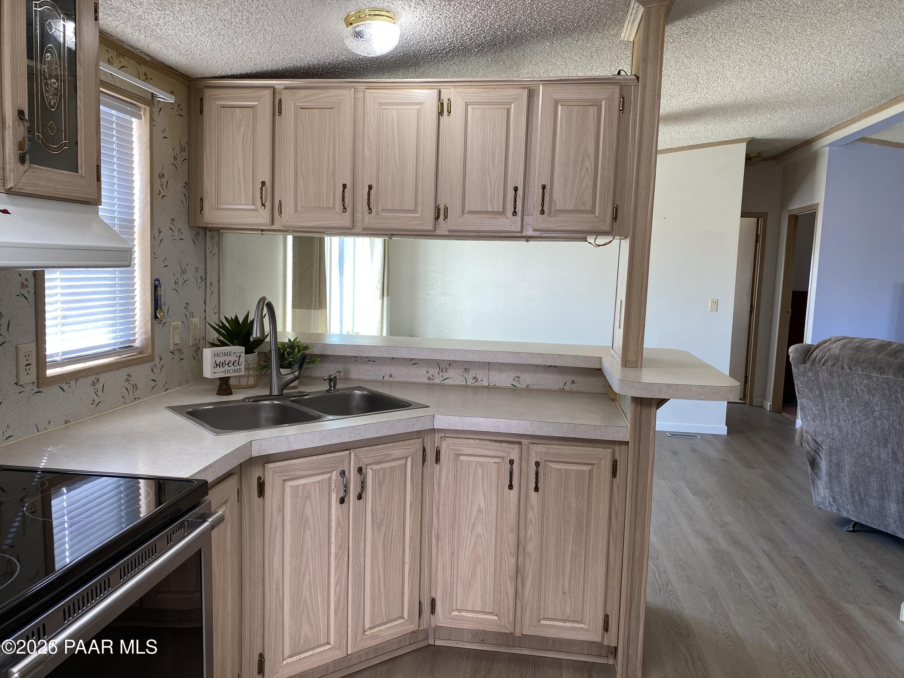 24725 North Patricia Road Paulden, AZ 86334 - Photo 8 of 30 a kitchen with granite countertop a sink and cabinets