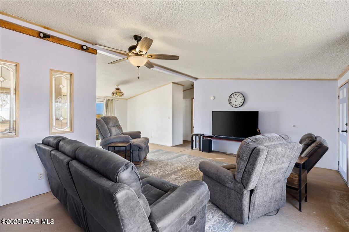 24725 North Patricia Road Paulden, AZ 86334 - Photo 8 of 36 a living room with furniture a ceiling fan and a window