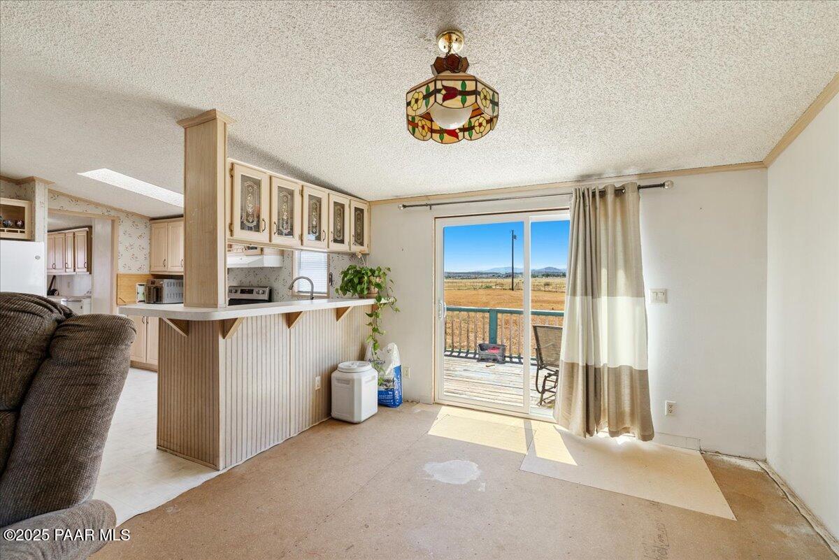 24725 North Patricia Road Paulden, AZ 86334 - Photo 10 of 36 a view of a living room and kitchen with furniture and a large window