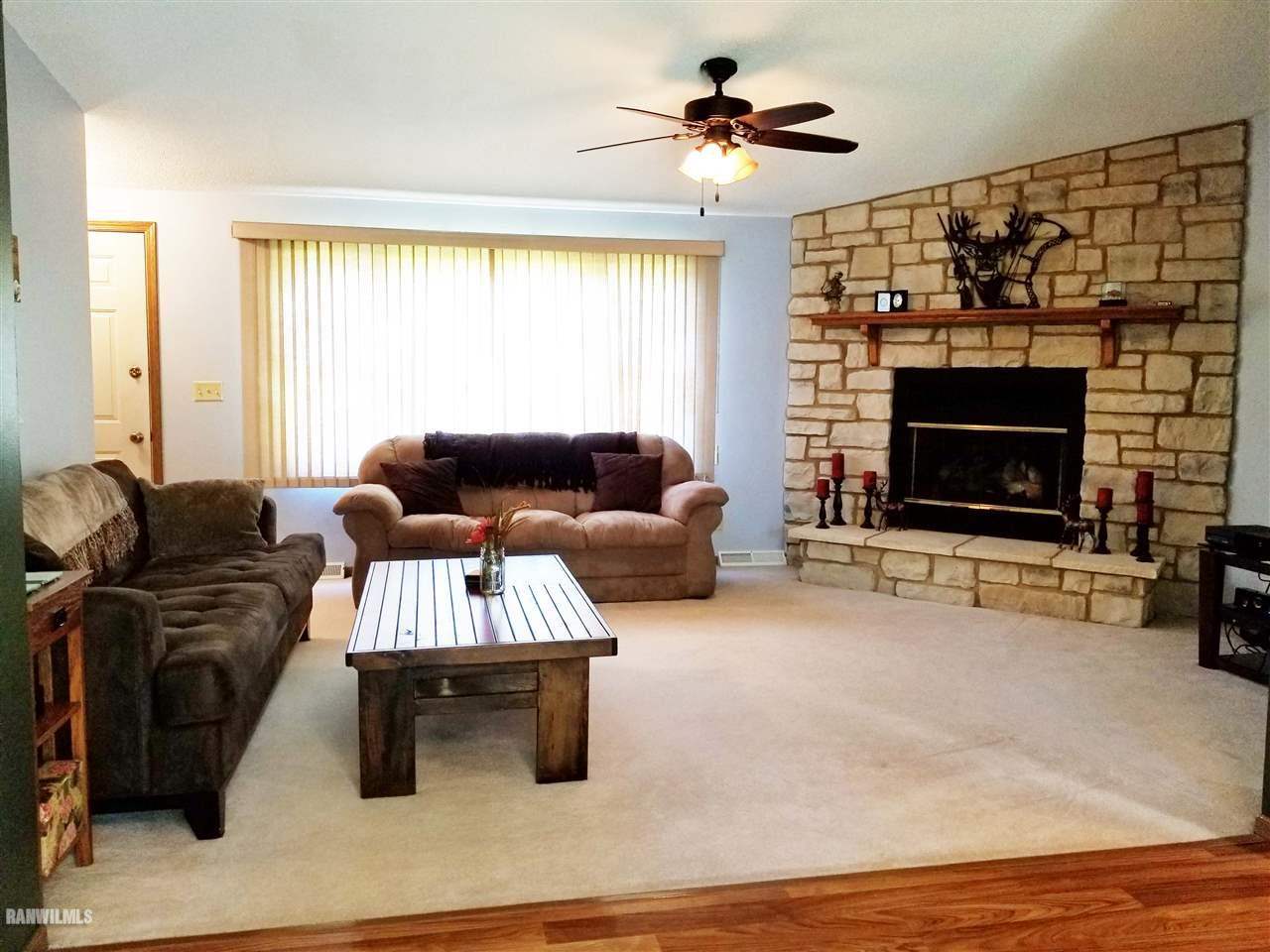 202 West Division Road Shannon, IL 61078 - Photo 9 of 14 a living room with furniture and a fireplace
