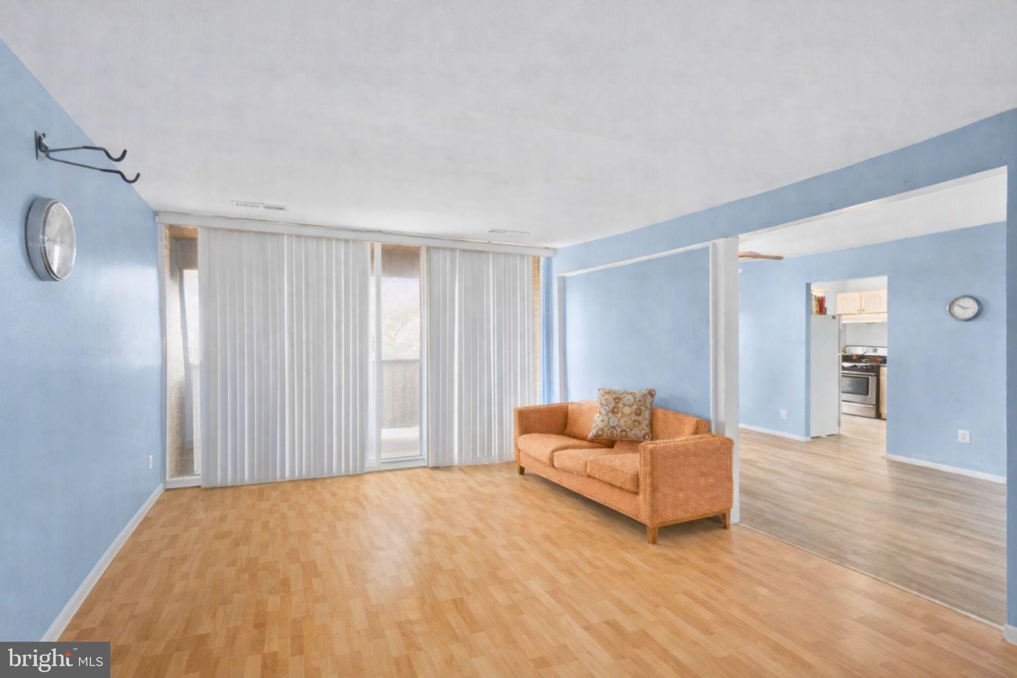 7957 Riggs Road, Unit 11 Hyattsville, MD 20783 - Photo 5 of 19 a living room with furniture and a wooden floor