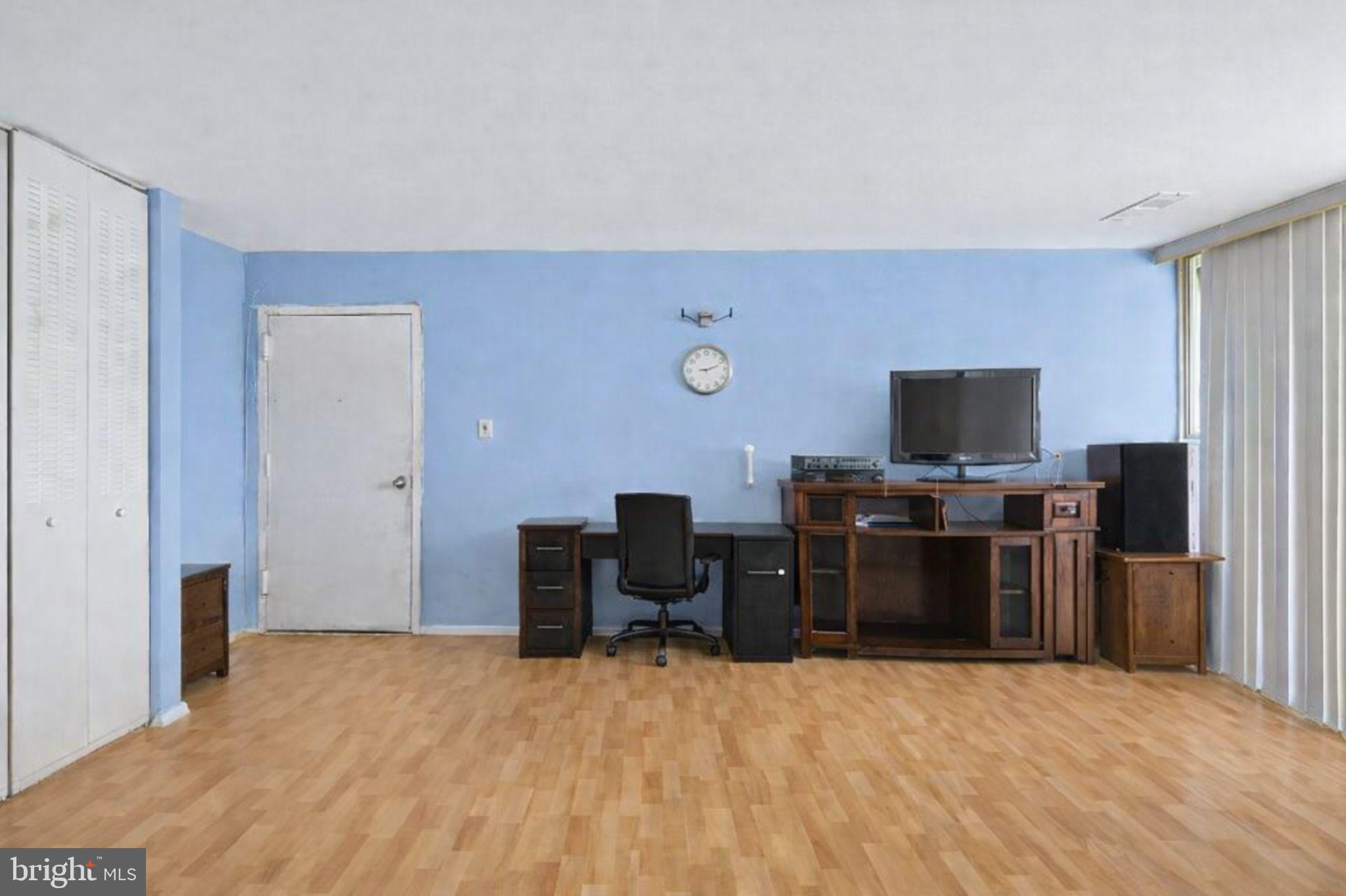 7957 Riggs Road, Unit 11 Hyattsville, MD 20783 - Photo 6 of 19 a bedroom with a bed and a flat screen tv