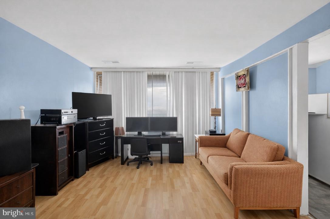 7957 Riggs Road, Unit 11 Hyattsville, MD 20783 - Photo 7 of 19 a living room with furniture and a flat screen tv