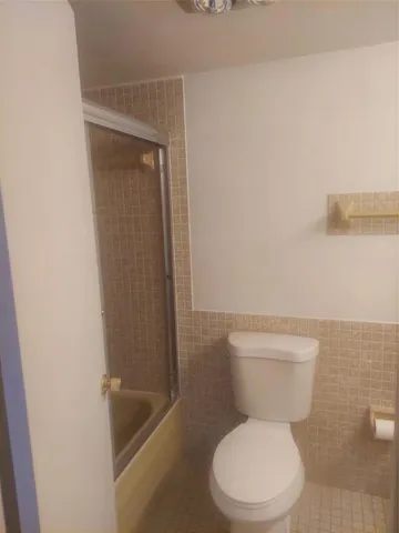 a bathroom with a toilet and a vanity