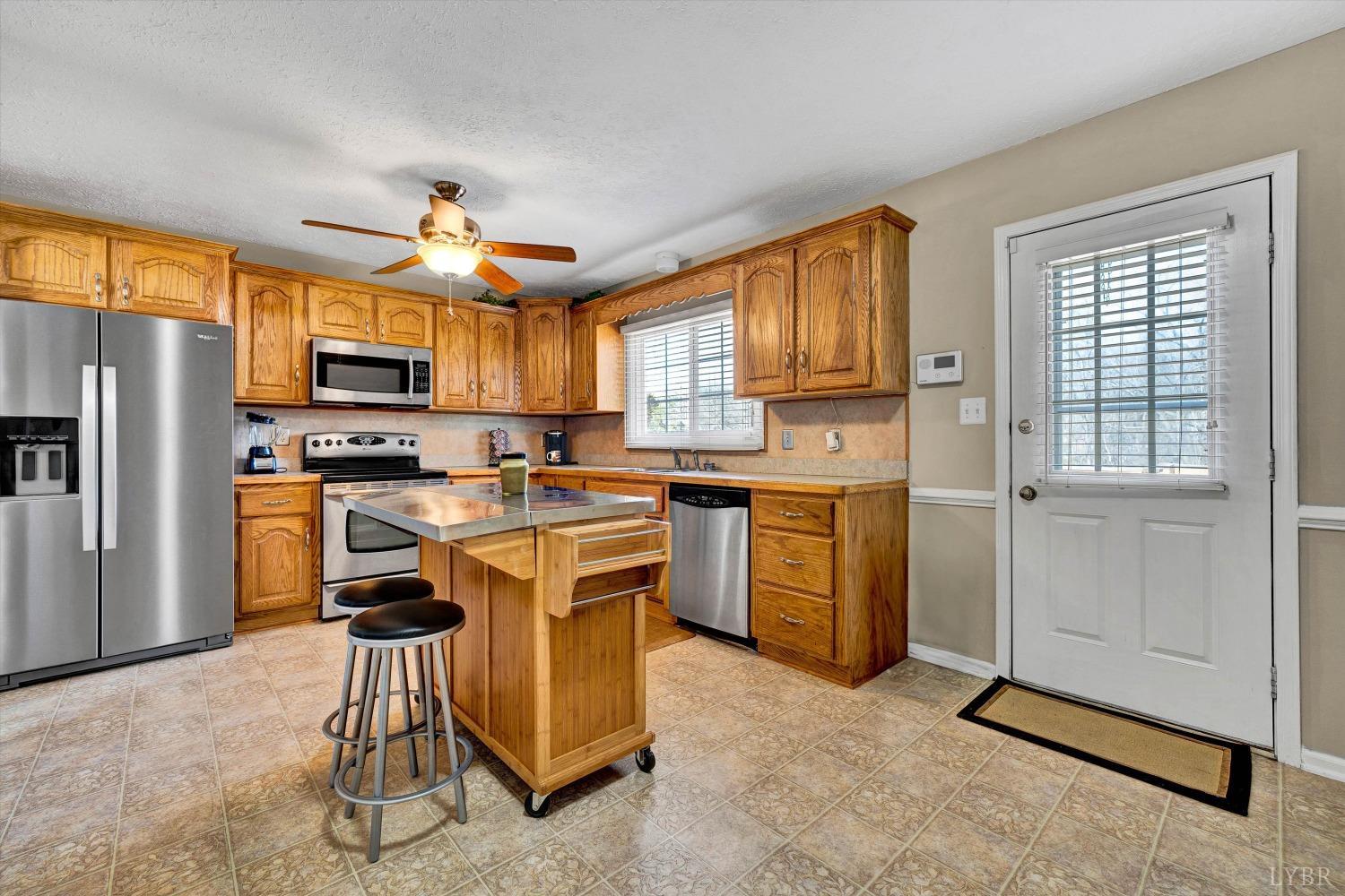 505 Sweeney Circle Forest, VA 24551 - Photo 8 of 29 a kitchen with a refrigerator a stove top oven a sink dishwasher and cabinets