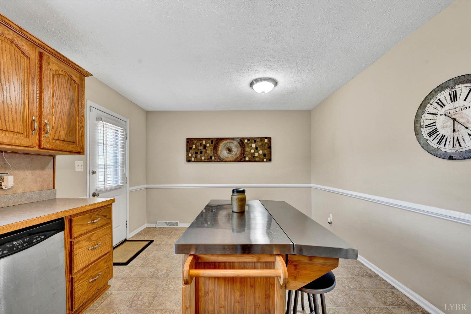 505 Sweeney Circle Forest, VA 24551 - Photo 9 of 29 a view of a kitchen with a sink and a refrigerator