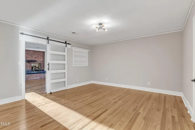 wooden floor in an empty room with a window
