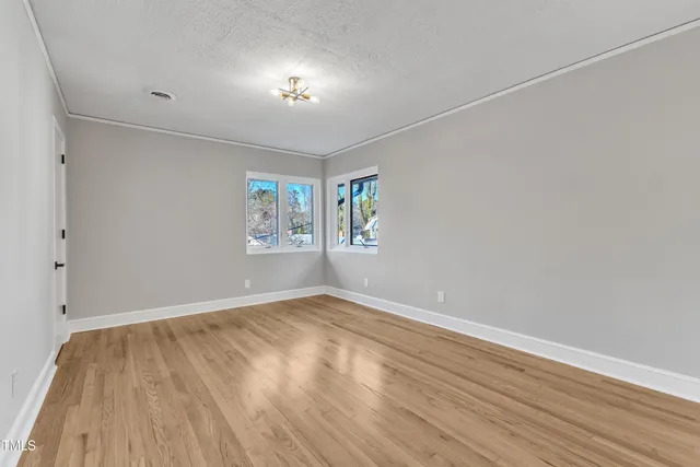 a view of a swimming pool with back yard of the house