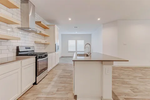 a kitchen with stainless steel appliances a sink and cabinets