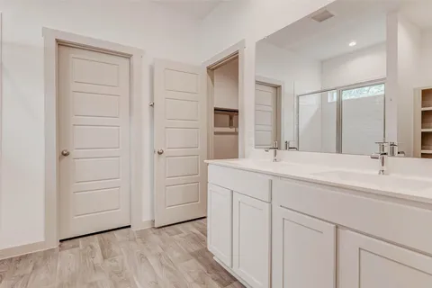 a bathroom with a double vanity sink and mirror