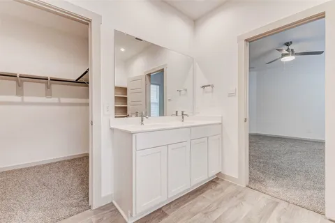 a bathroom with a double vanity sink a mirror and shower