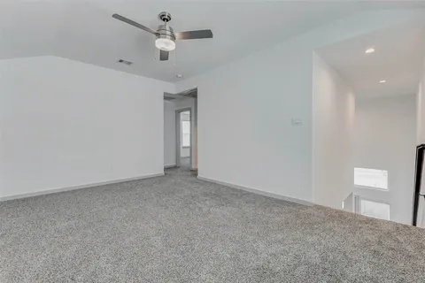 a view of an empty room and a ceiling fan