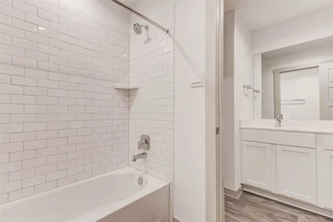 a bathroom with a bathtub and shower