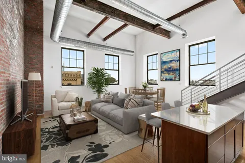 a living room with furniture a flat screen tv and a window