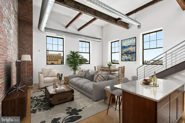 a living room with furniture a flat screen tv and a window