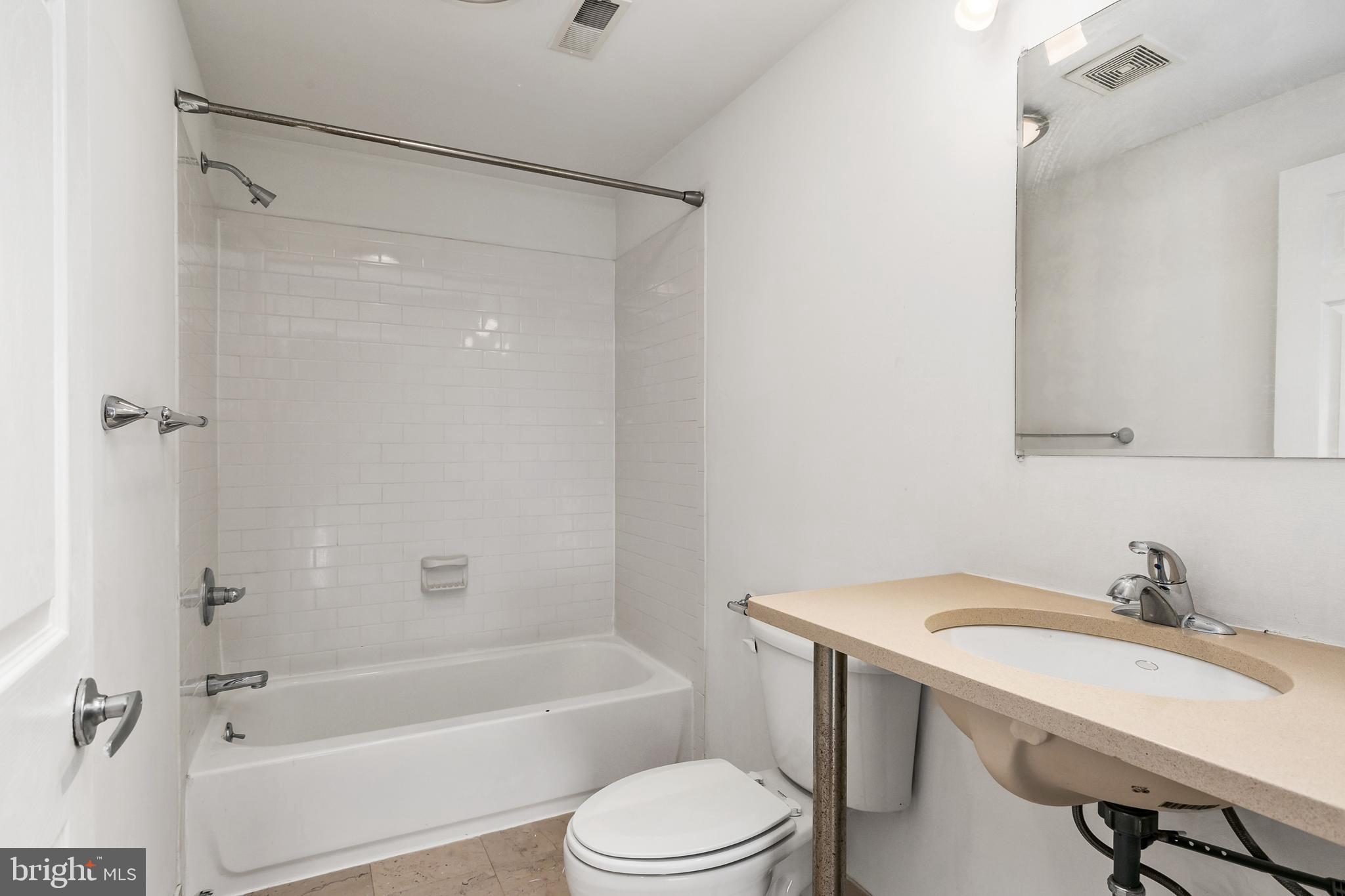 1637-39 Poplar Street, Unit S4 Philadelphia, PA 19130 - Photo 12 of 26 a bathroom with a sink toilet and shower