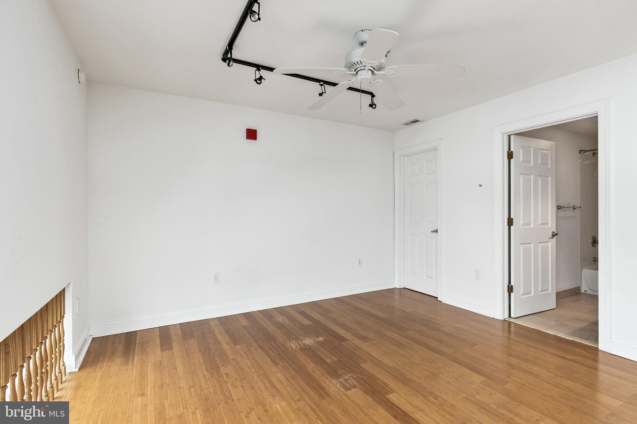 1637-39 Poplar Street, Unit S4 Philadelphia, PA 19130 - Photo 18 of 26 a view of a room with wooden floor and ceiling fan