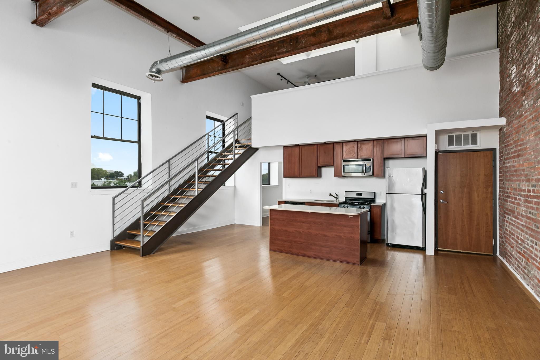 1637-39 Poplar Street, Unit S4 Philadelphia, PA 19130 - Photo 8 of 26 a room with wooden floors and stairs