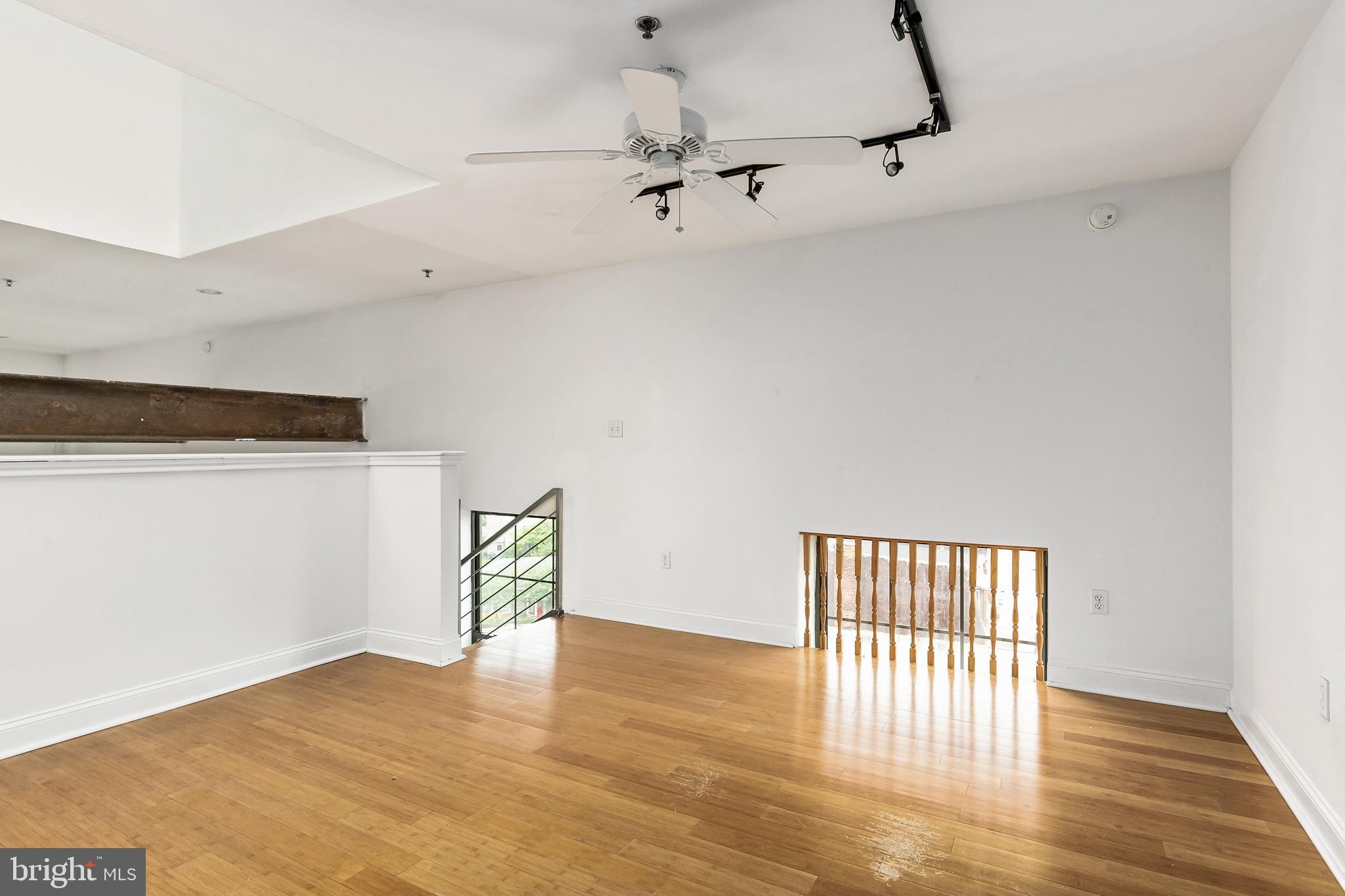 1637-39 Poplar Street, Unit S4 Philadelphia, PA 19130 - Photo 9 of 26 a view of an empty room with a window and wooden floor