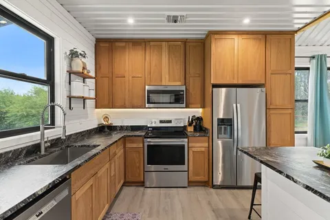 a kitchen with a sink stove and refrigerator