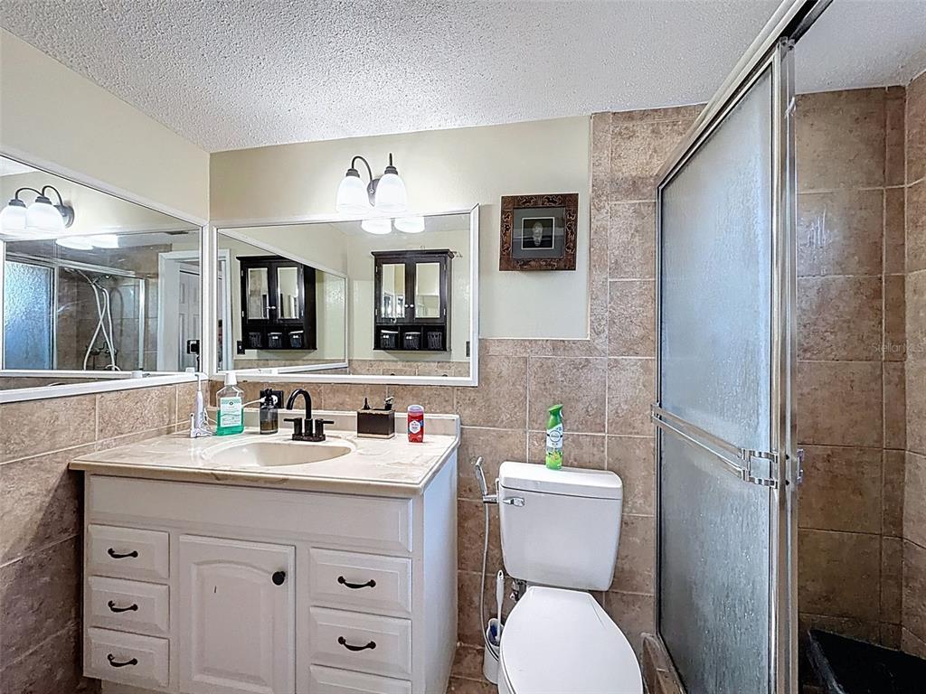 9610 Rainbow Lane Port Richey, FL 34668 - Photo 18 of 34 a bathroom with a toilet sink and mirror
